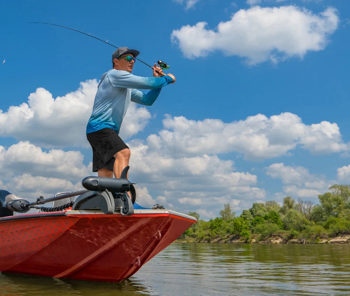 Angler casting line on sunny day