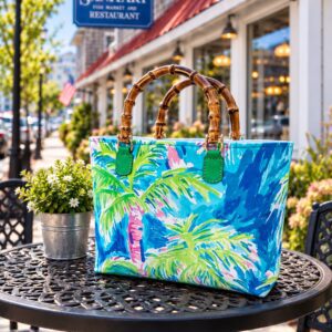 Colorful tropical-print tote with bamboo handles on table
